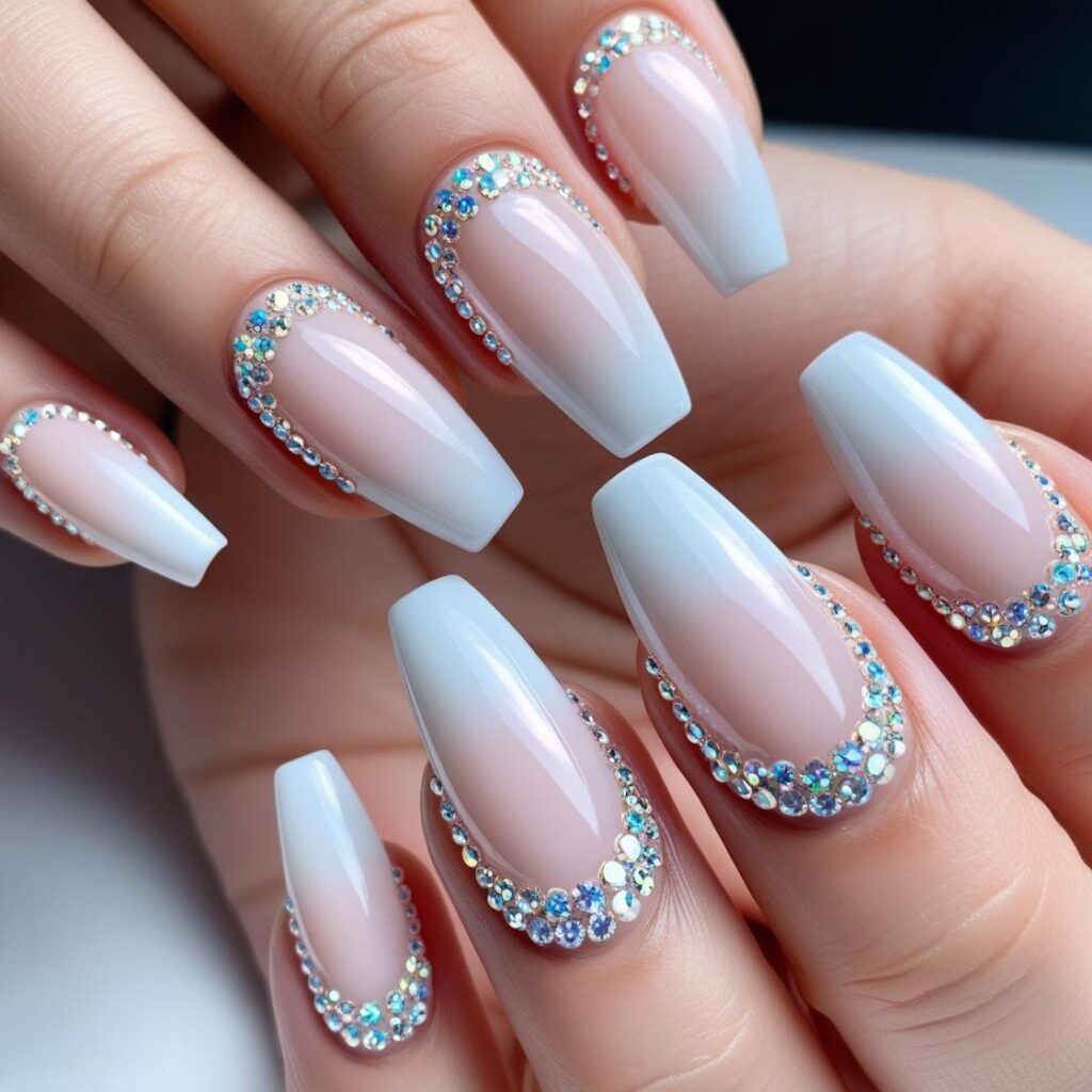 Coffin-shaped nails with rows of tiny rhinestones along the base of each nail for a touch of bling
